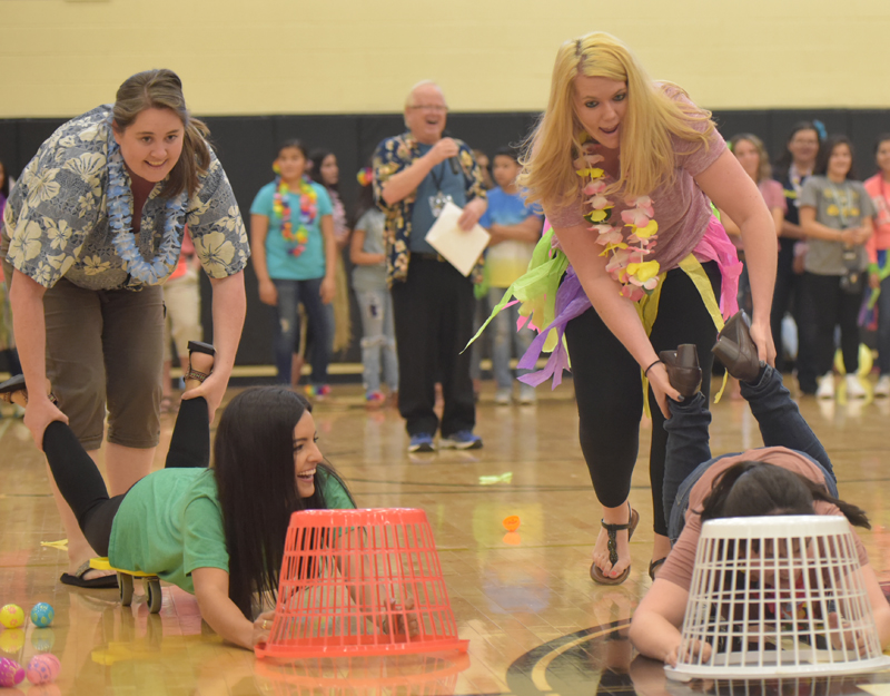 teachers pushing other teachers with laundry baskets