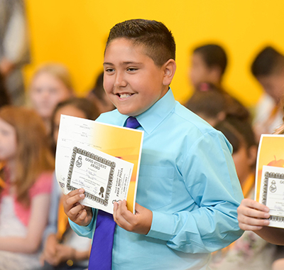 kid smiling with certificate