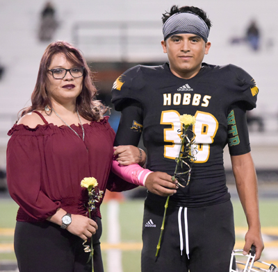 football player standing with mom