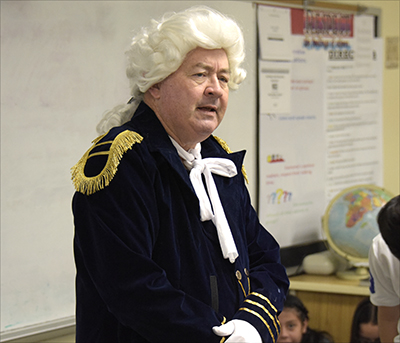 man dressed in white wig and uniform