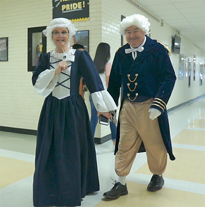 man and woman in colonial costume