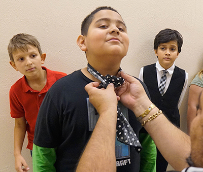 boy having getting his tie fixed