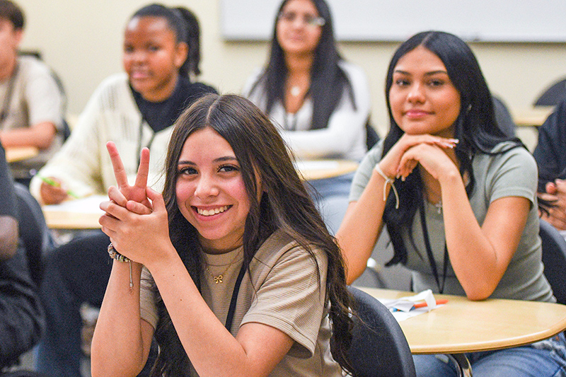 girl giving a peace sign