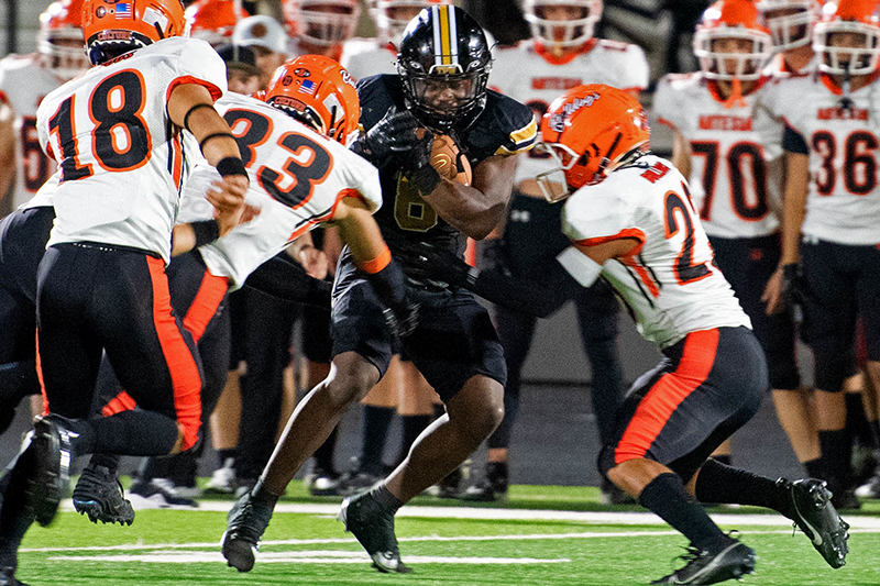 player running with ball through crowd