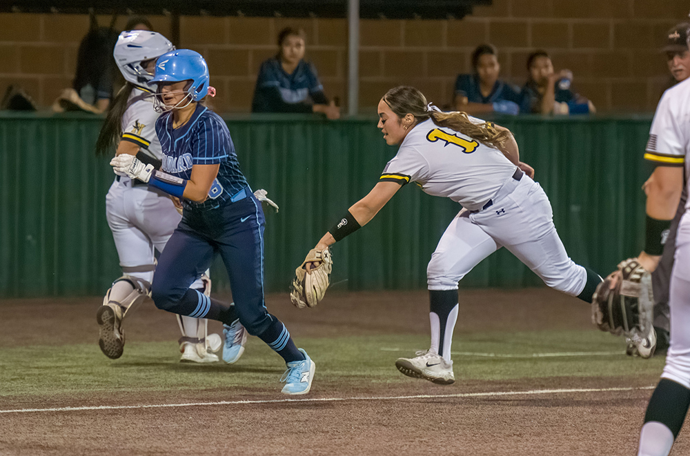 girl player running down another on baseline