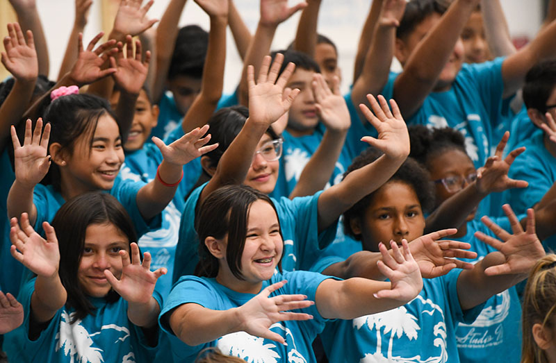 students waving