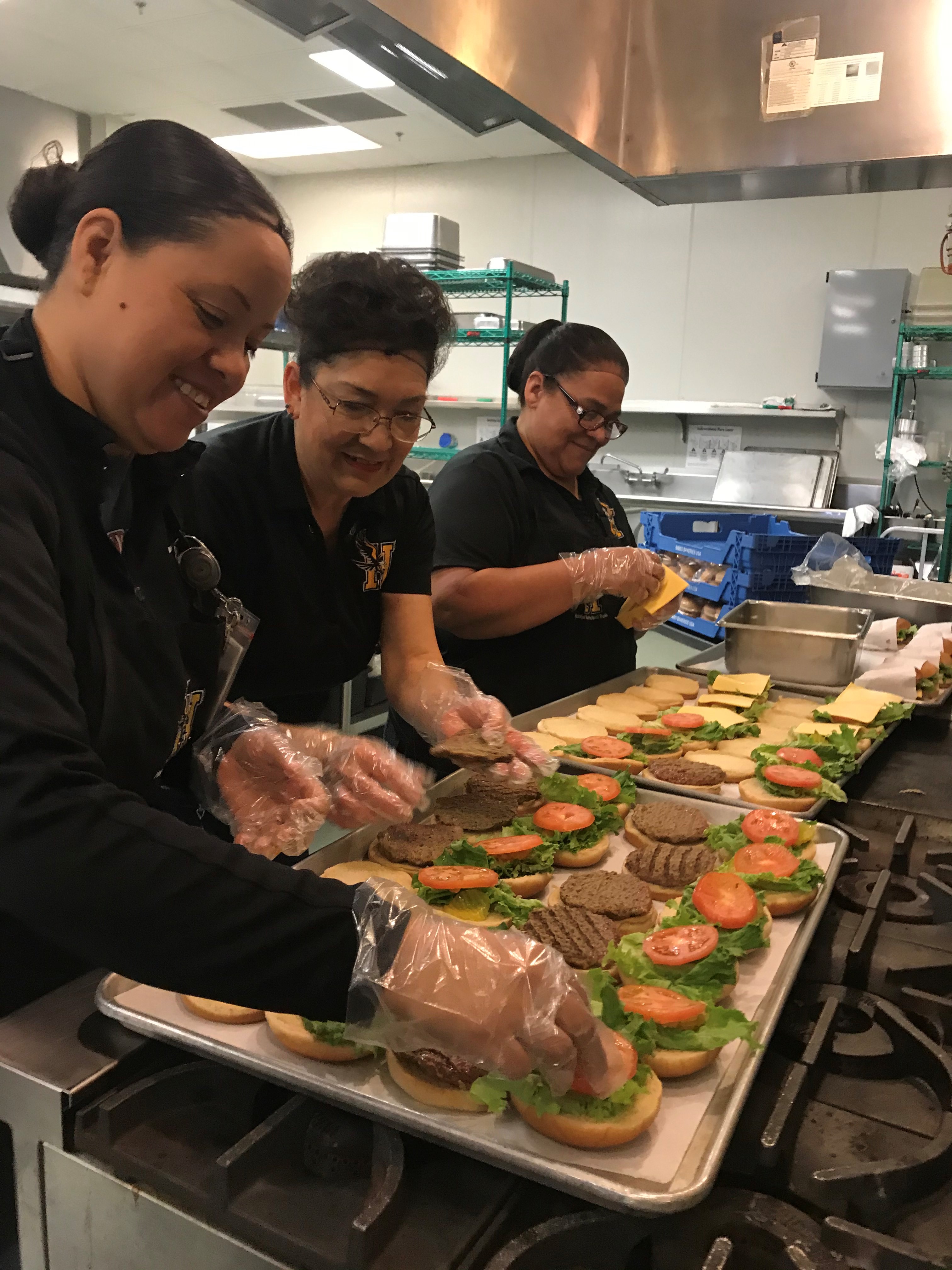 kitchen staff making sandwiches